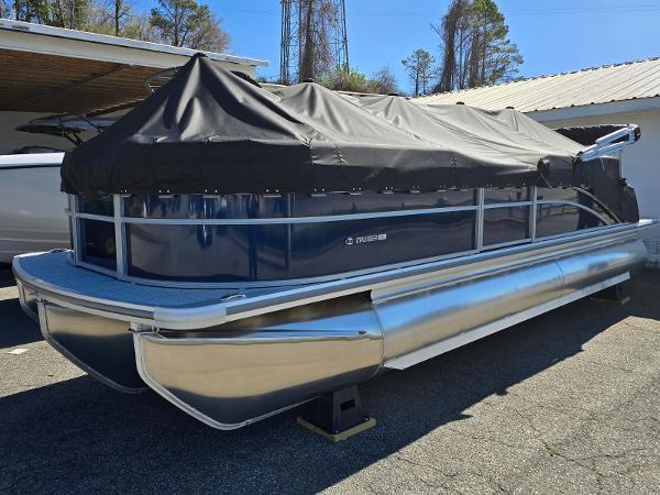 Harris Cruiser 230 2025 Harris Cruiser 230 pontoon boat covered, parked outdoors.