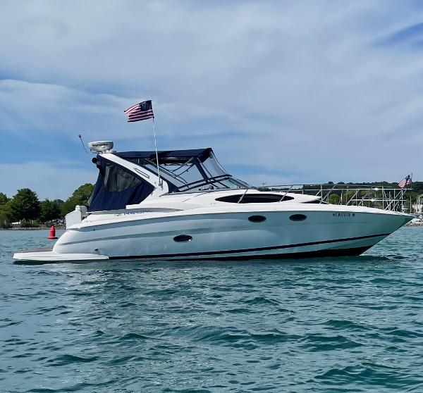 Regal 3360 Window Express 2008 Regal 3360 Window Express boat on water, American flag, clear sky.