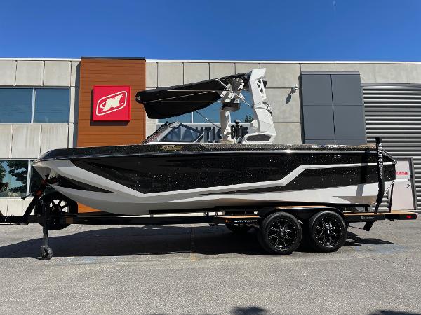 Nautique Super Air Nautique GS22 2025 Nautique Super Air Nautique GS22 boat on trailer, parked outside a building.