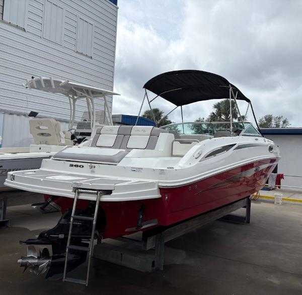 Sea Ray 260 Sundeck 2011 Sea Ray 260 Sundeck boat with red hull, docked outdoors.
