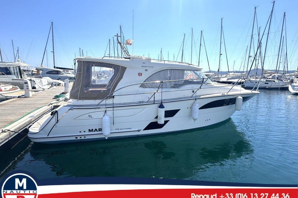 Marex 310 Sun Cruiser 2018 Marex 310 Sun Cruiser docked at marina, clear blue sky.