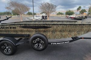 Tracker Grizzly 1650 T Prairie Wings Edition 2025 Tracker Grizzly 1650 T Prairie Wings Edition boat with camouflage design in parking lot.