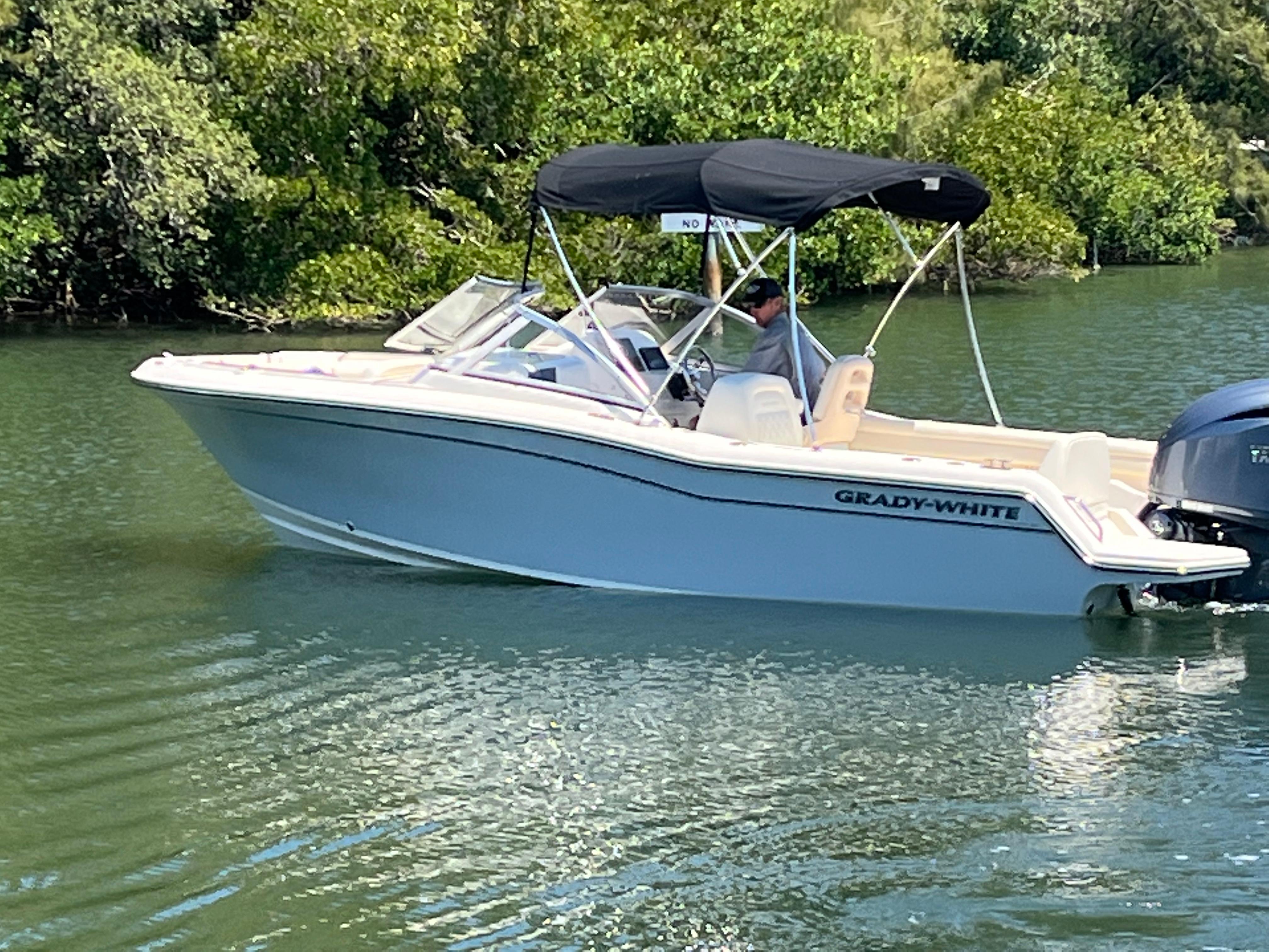 Grady-White Freedom 215 2022 Grady-White Freedom 215 boat cruising on a calm, green waterway.