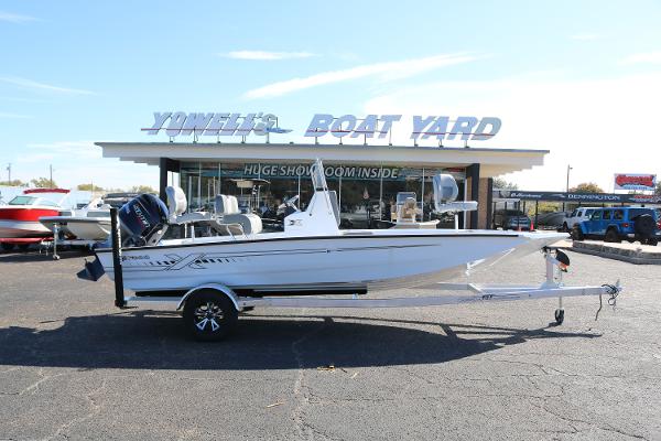 Xpress H20B 2025 Xpress H20B boat on trailer at dealership, sunny day.
