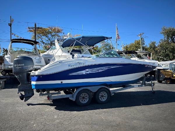 NauticStar 223DC Sport Deck 2014 NauticStar 223DC Sport Deck boat on trailer, parked outdoors.