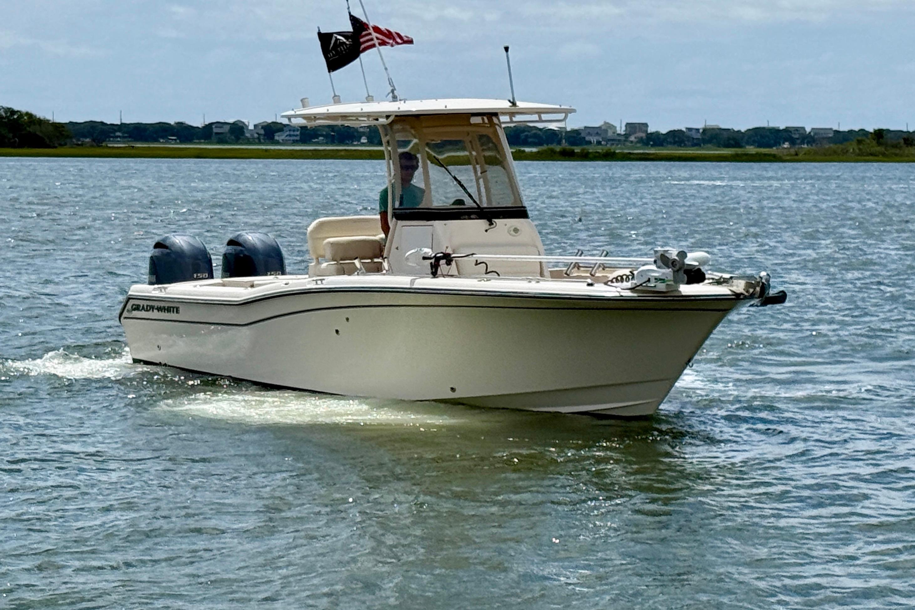 Grady-White Fisherman 257 2020 Grady-White Fisherman 257 boat cruising on a calm lake with dual engines.