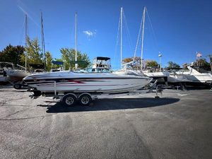 Formula 292 FASTech 2004 Formula 292 FASTech boat on trailer in marina under clear blue sky.