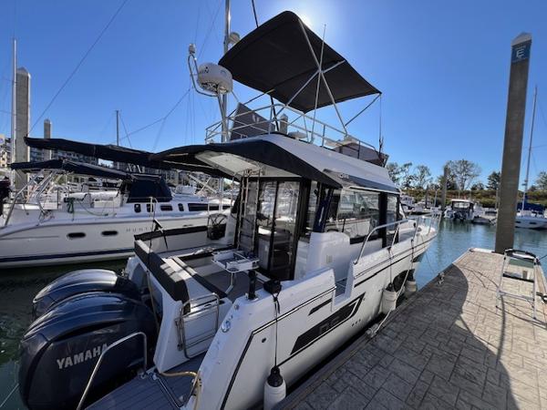 Jeanneau NC 1095 Fly 2021 Jeanneau NC 1095 Fly yacht docked, featuring dual Yamaha engines and spacious flybridge.