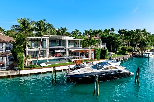 Sunseeker Predator 60 Sunseeker Predator 60 yacht docked by a luxurious waterfront mansion, 2010 model.