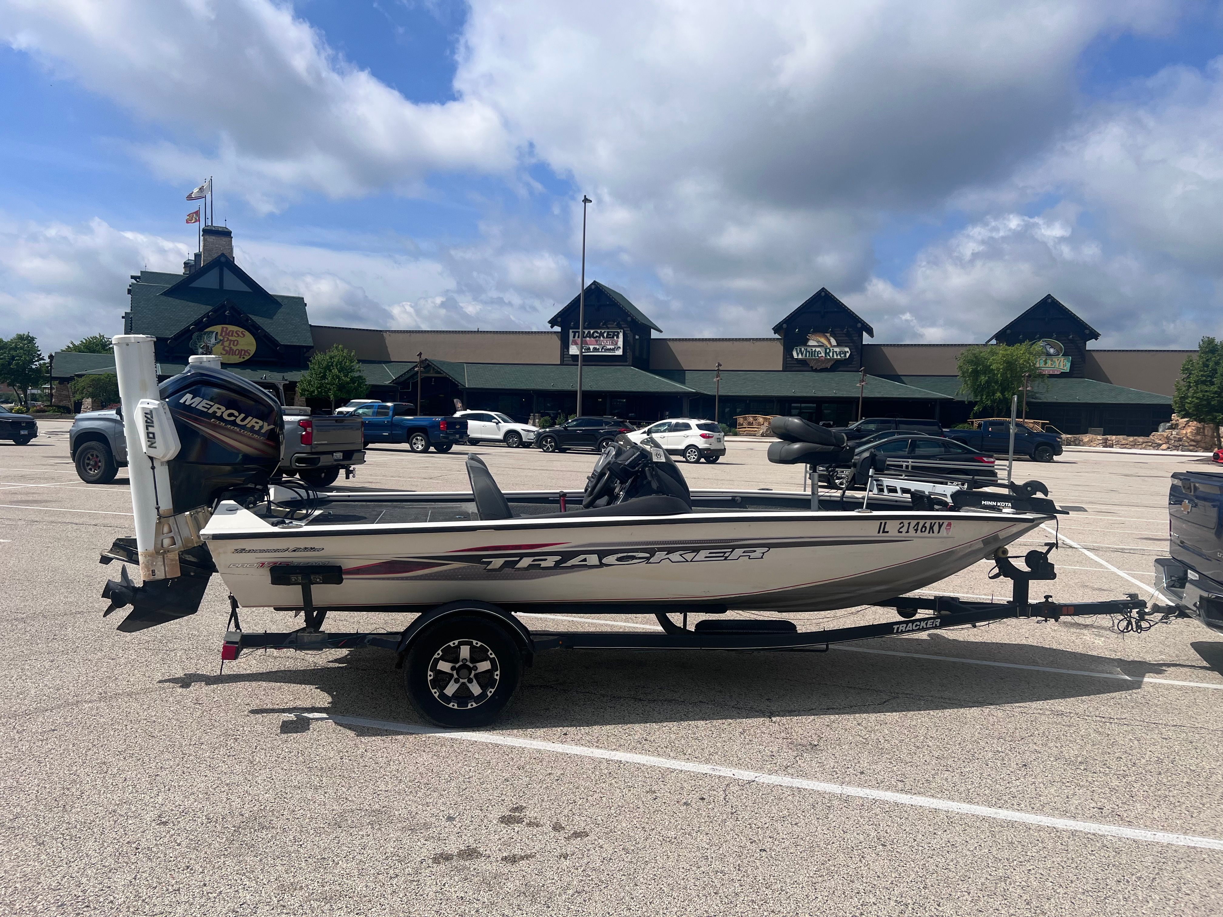Tracker PRO 175 TE 2019 Tracker PRO 175 TE boat on trailer in parking lot, Bass Pro Shops in background.
