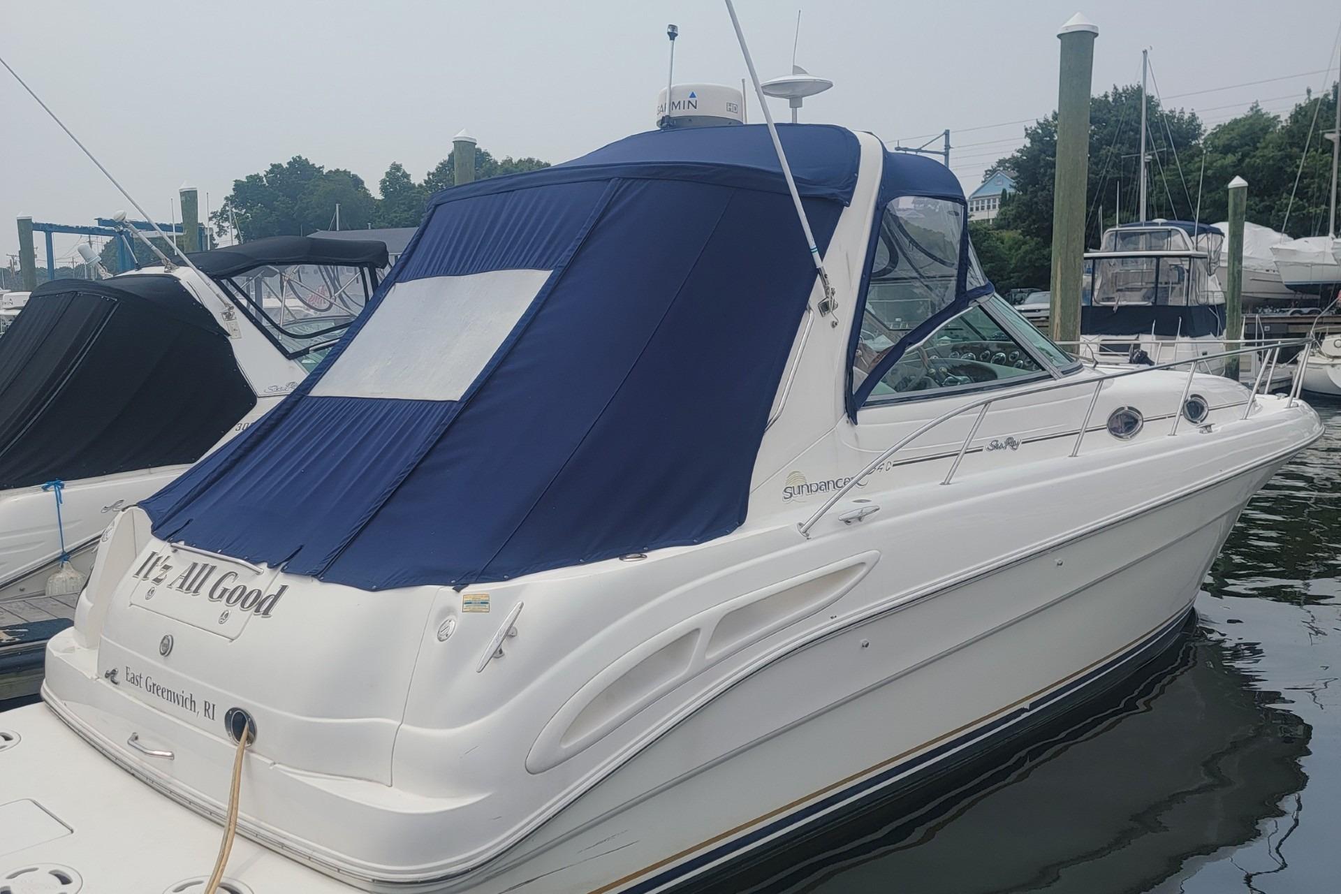 Sea Ray 340 Sundancer 2001 Sea Ray 340 Sundancer docked with blue canopy in marina.