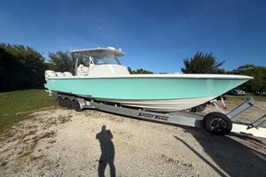 Contender 39 Fisharound 2023 Contender 39 Fisharound boat on trailer, light blue hull, parked outdoors.