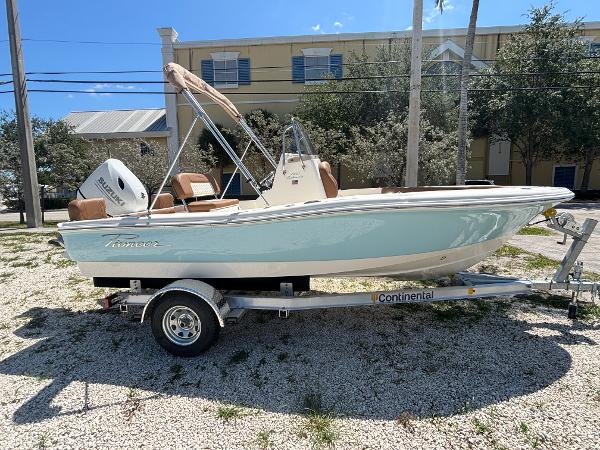 Pioneer 180 Islander 2025 Pioneer 180 Islander boat on trailer, parked outdoors, sunny day.