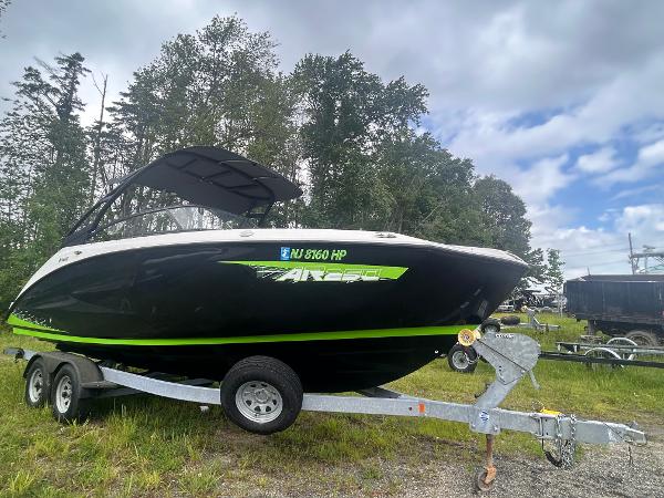 Yamaha Boats AR250 2021 Yamaha Boats AR250 on trailer, parked outdoors with trees and cloudy sky in background.