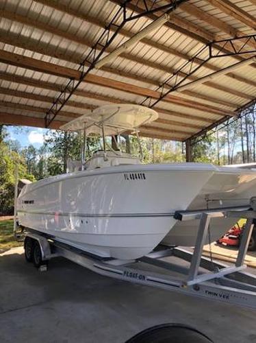 Twin Vee 240 GFX CC 2022 Twin Vee 240 GFX CC boat on trailer under a metal canopy.