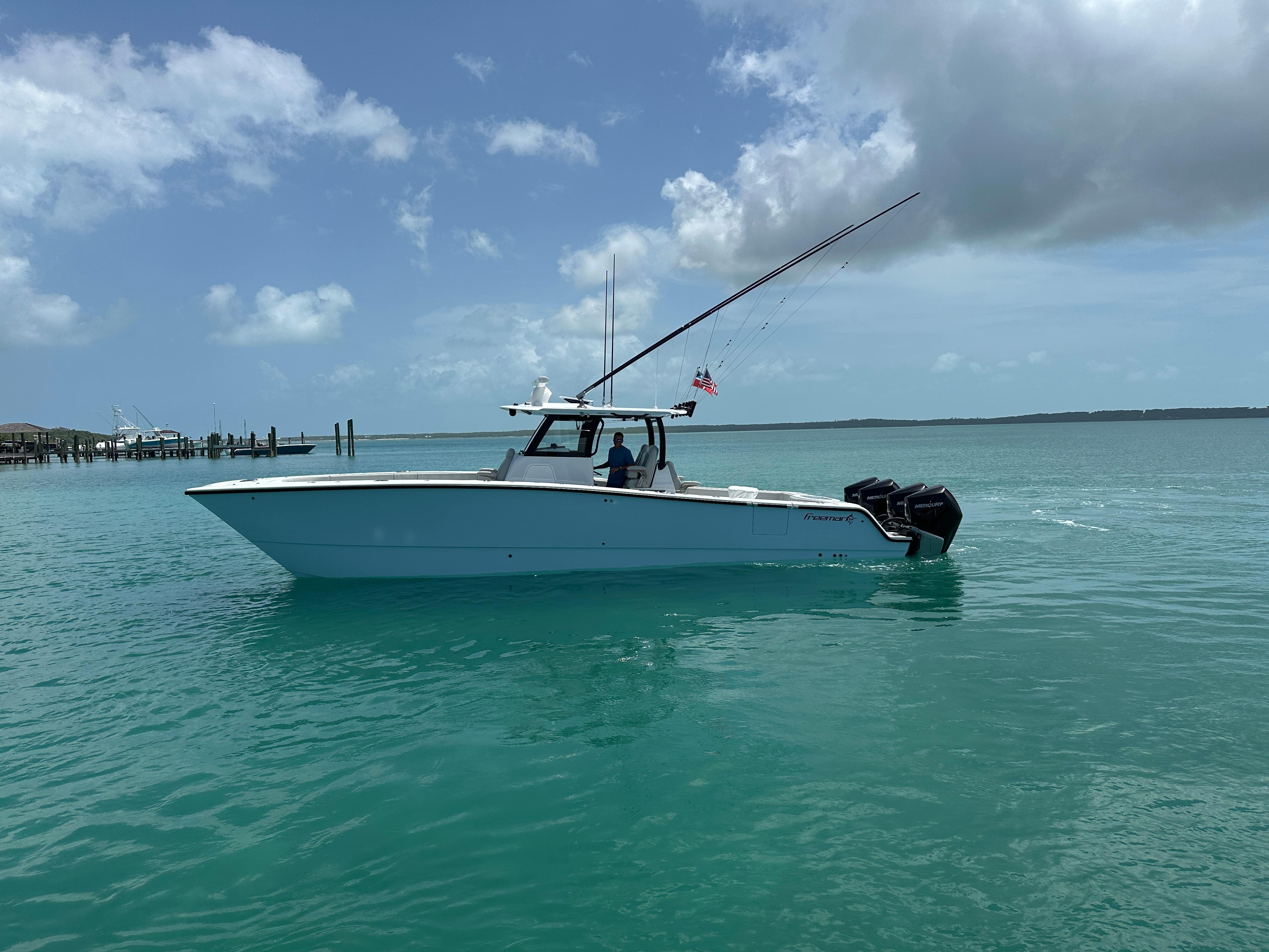 Freeman 38 2025 Freeman 38 boat on turquoise water under a partly cloudy sky.