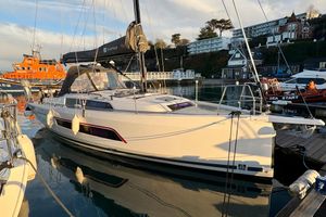 Dufour 37 2023 Dufour 37 yacht docked in a marina, with lifeboat in background.