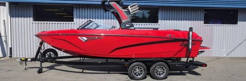 Tigé Z3 2024 Tigé Z3 red wakeboard boat on trailer, side view.