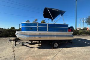 Sun Tracker Party Barge 16 DLX 2026 Sun Tracker Party Barge 16 DLX pontoon boat on trailer, sunny day.