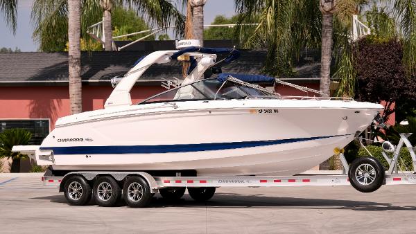 Chaparral 30 Surf 2021 Chaparral 30 Surf boat on a trailer in a driveway.
