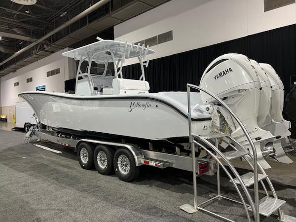 Yellowfin 36 Offshore 2024 Yellowfin 36 Offshore boat on trailer with Yamaha engines at indoor exhibit.