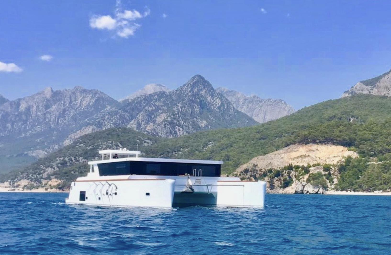 Ocean Explorer Catamarans Ocean Explorer 65 Ocean Explorer 65 catamaran sailing near scenic mountainous coastline, 2020 model.