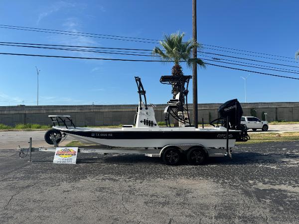 Shallow Sport 24 Sport 2023 Shallow Sport 24 Sport boat on trailer, parked outdoors under clear sky.