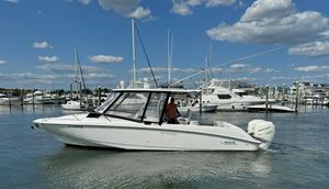 Boston Whaler 32 Outrage Cuddy 2006 Boston Whaler 32 Outrage Cuddy boat in marina under blue sky.