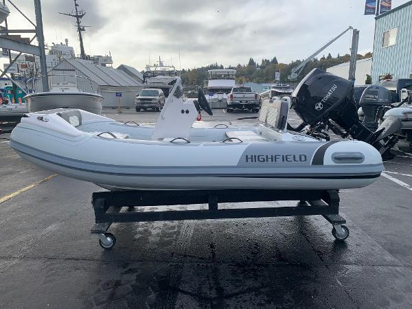 Highfield Sport 330 2023 Highfield Sport 330 inflatable boat on a wheeled stand in a marina.