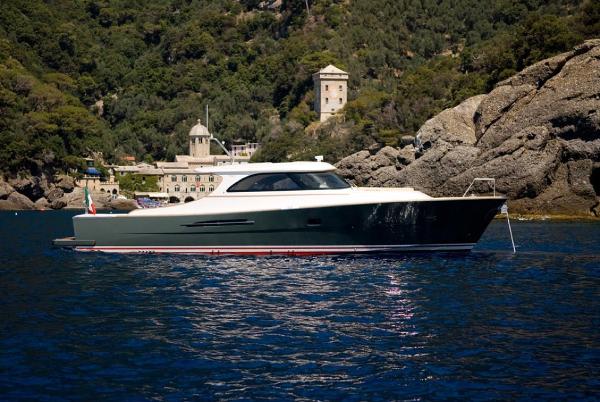 Toy 51 Luxurious Toy 51 yacht cruising near rocky coastline, 2025 model.