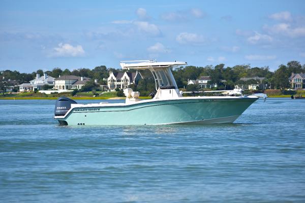 Grady-White Fisherman 236 2021 Grady-White Fisherman 236 boat on calm water near shoreline homes.
