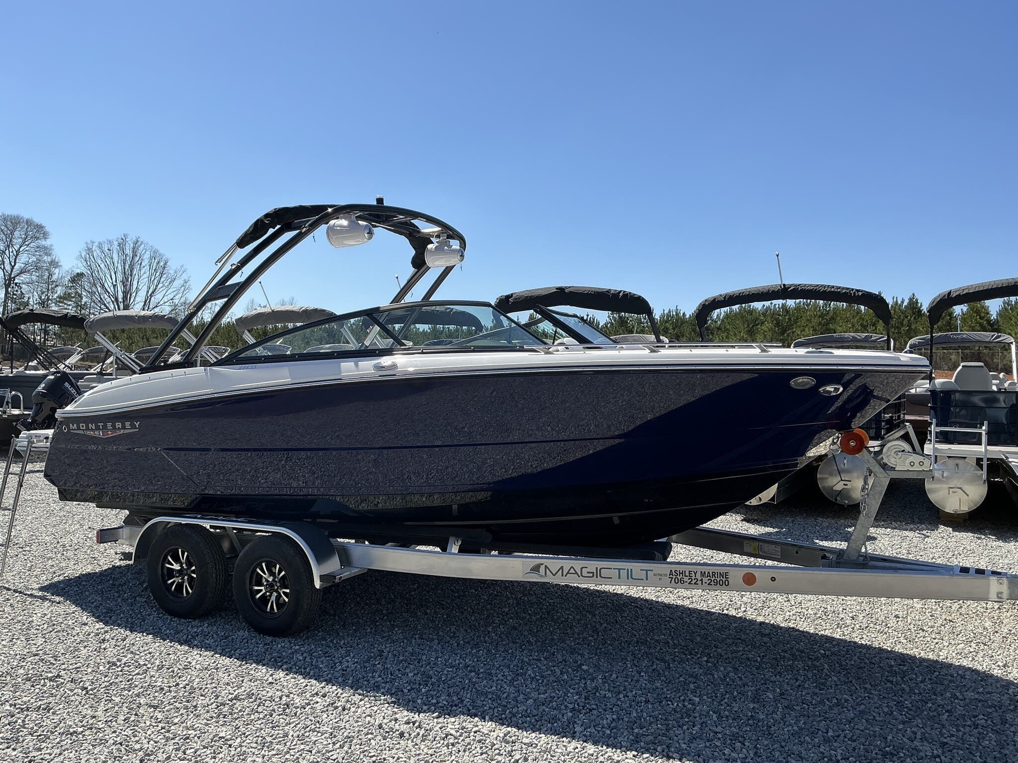 Monterey 238SS Super Sport 2025 Monterey 238SS Super Sport boat on trailer, parked outdoors under clear blue sky.