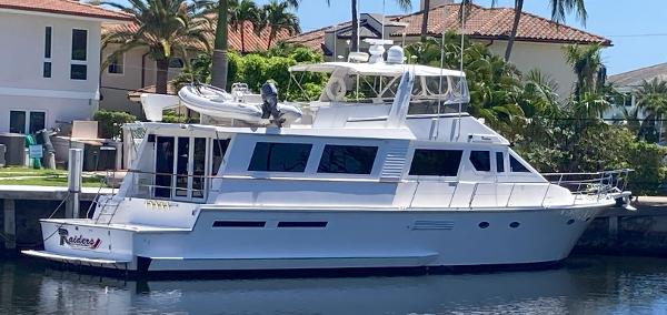 Viking 70 Cockpit Motor Yacht 1988 Viking 70 Cockpit Motor Yacht docked near waterfront homes.