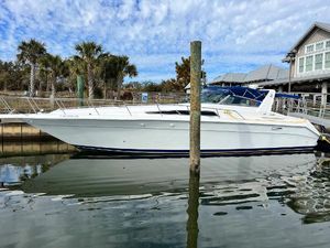 Sea Ray 440 Sundancer 1993 Sea Ray 440 Sundancer yacht docked at marina with palm trees and blue sky.
