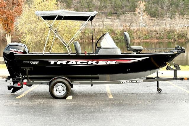 Tracker Pro Guide V-16 WT 2025 Tracker Pro Guide V-16 WT boat with canopy on trailer, parked outdoors.