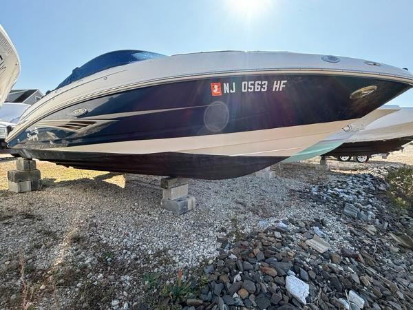 Sea Ray 210 Select 2010 Sea Ray 210 Select boat on blocks, sunny day, gravel ground.