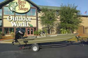 Tracker Grizzly 1860 CC 2026 Tracker Grizzly 1860 CC boat on trailer outside Bass Pro Shops Outdoor World.