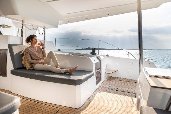Fountaine Pajot Aura 51 Woman relaxing on the deck of a 2025 Fountaine Pajot Aura 51 yacht.