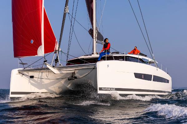 Fountaine Pajot Aura 51 2025 Fountaine Pajot Aura 51 catamaran sailing with red sails on open water.