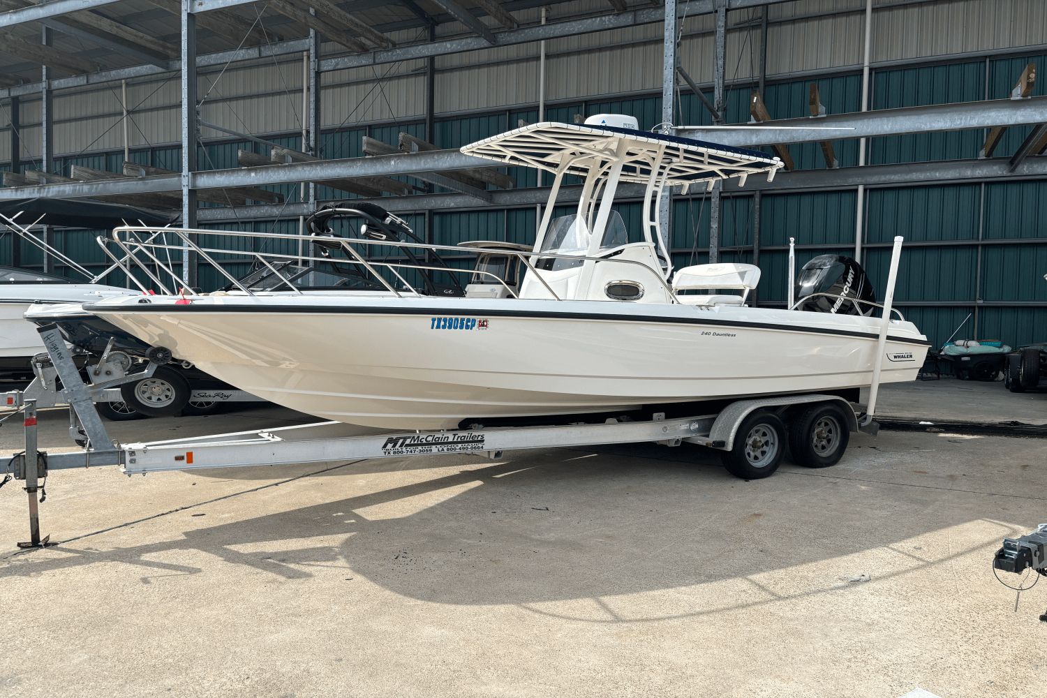 Boston Whaler 240 Dauntless 2014 Boston Whaler 240 Dauntless boat on trailer in storage facility.