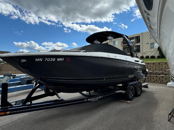 Monterey 258 Super Sport 2022 Monterey 258 Super Sport boat on trailer, parked outdoors under a partly cloudy sky.