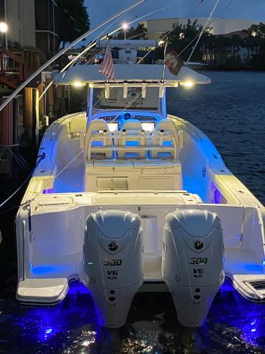 Grady-White Canyon 326 2024 Grady-White Canyon 326 boat with dual engines, illuminated at night by blue lights.