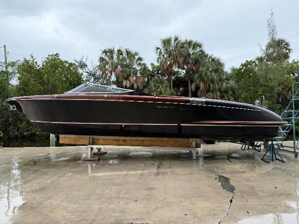 Riva Aquariva Super 2016 Riva Aquariva Super boat on dry dock, surrounded by lush greenery.