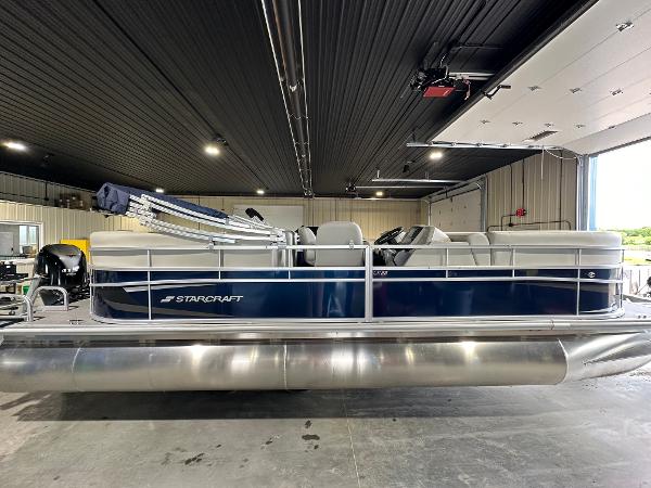 Starcraft LX22RDH 2024 Starcraft LX22RDH pontoon boat in a garage.