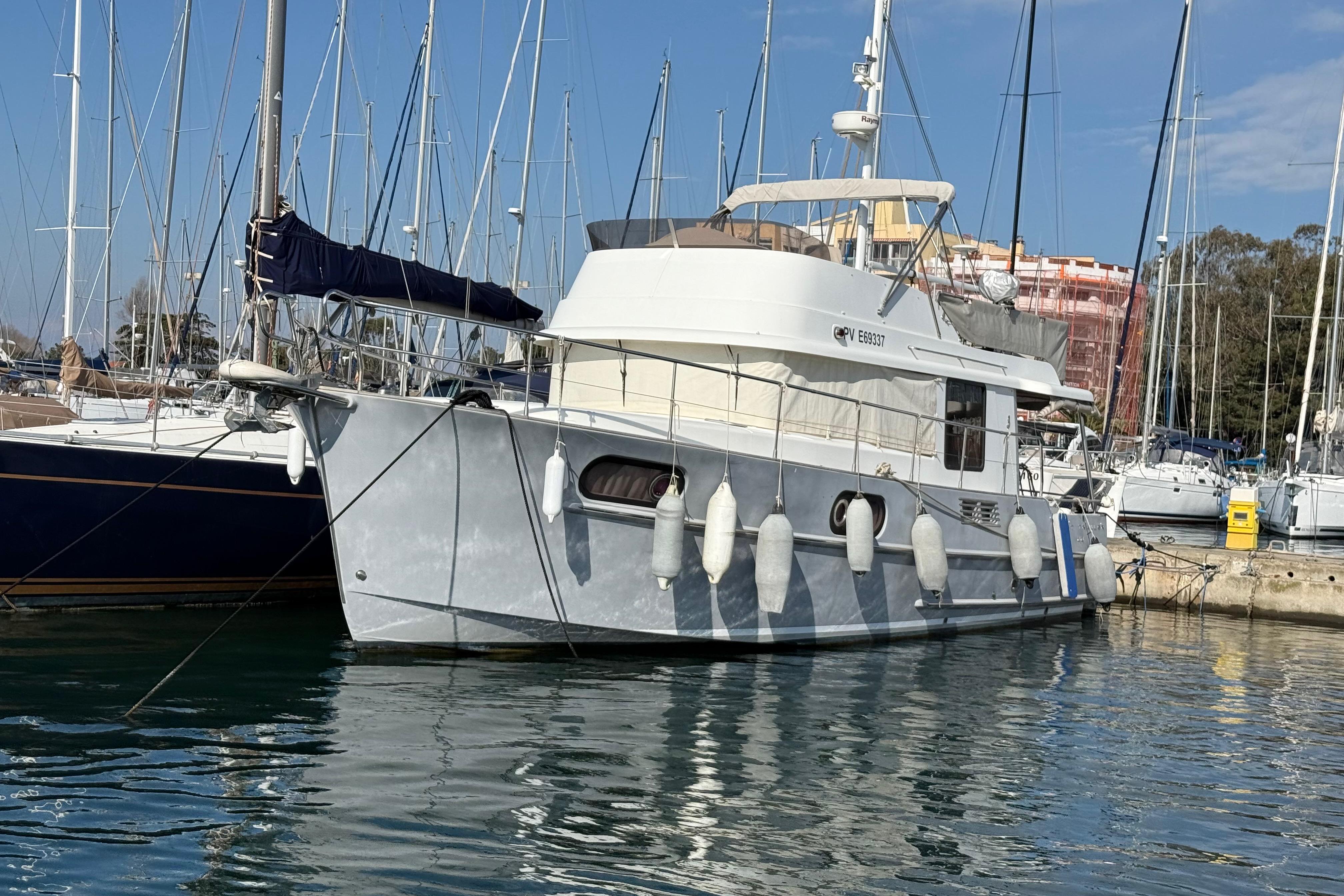 Beneteau Swift Trawler 44 2012 Beneteau Swift Trawler 44 docked in a marina, surrounded by sailboats.