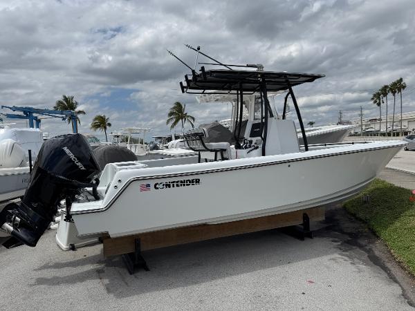 Contender 25 Tournament 2025 Contender 25 Tournament boat with Mercury outboard, parked on a lot under cloudy skies.