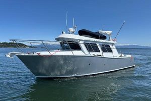 Coastal Craft 33 ProFish 2020 Coastal Craft 33 ProFish boat on calm water under clear blue sky.