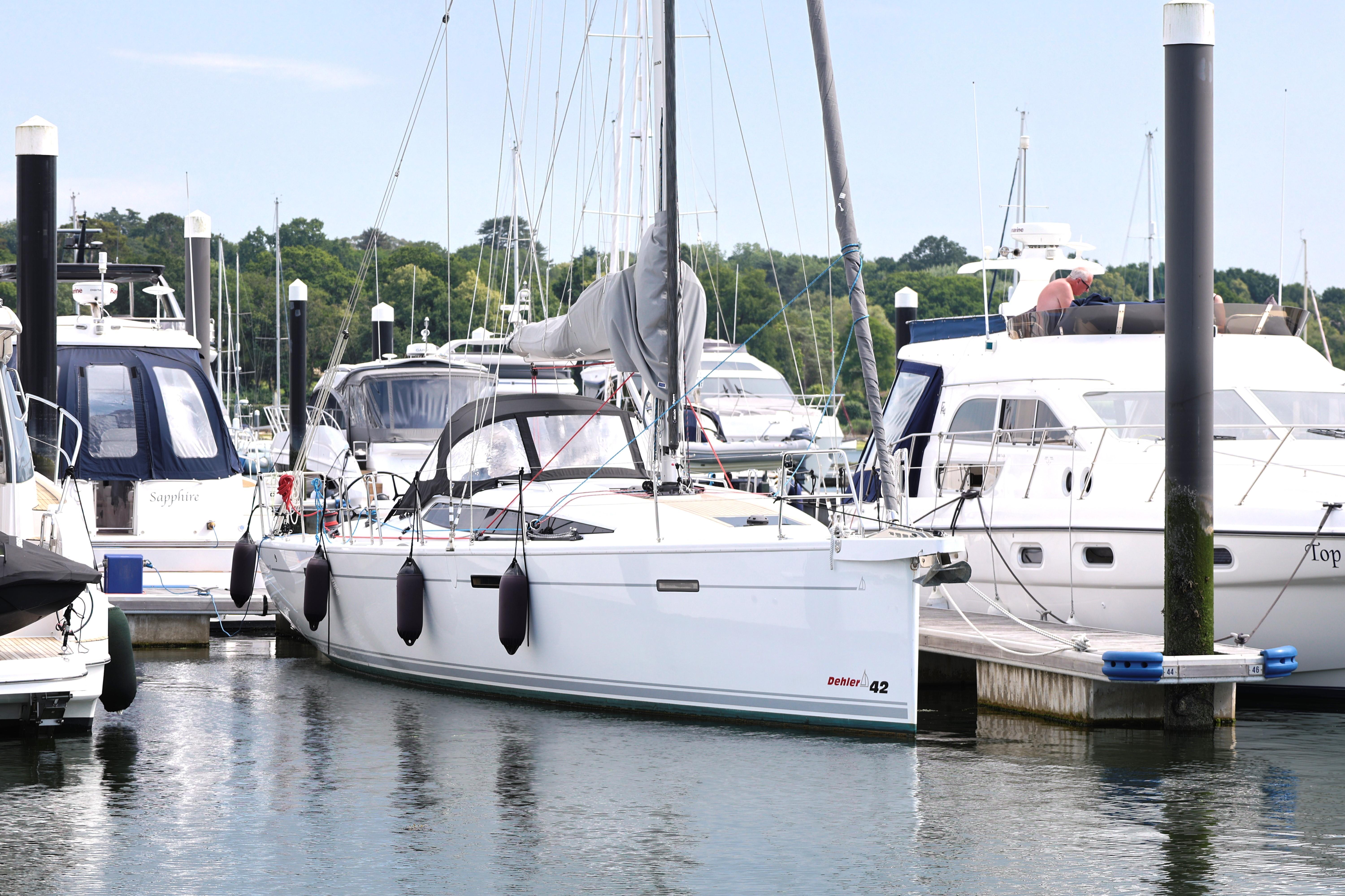 Dehler 42 2021 Dehler 42 yacht docked at marina, surrounded by other boats.