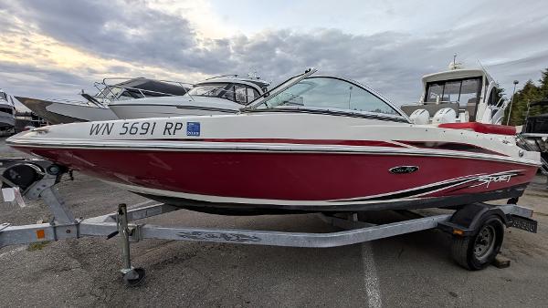 Sea Ray 175 Sport 2011 Sea Ray 175 Sport boat on trailer, red and white design, parked outdoors.