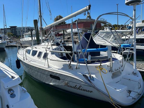 Hunter 320 2001 Hunter 320 sailboat docked in marina, sunny day.